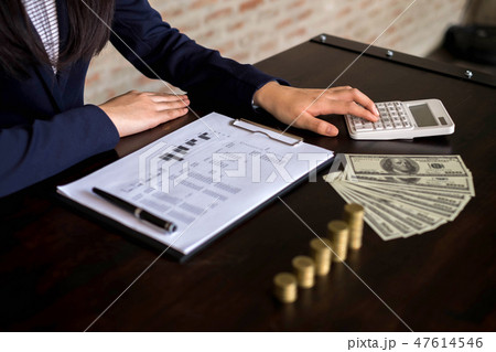 Woman calculate the income from export business. 47614546