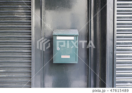 Green mailbox on a wall Green mailbox on a wall 47615489