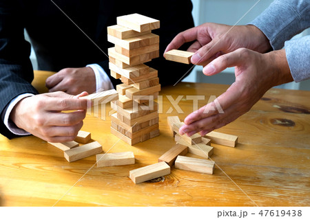 Businessmen picking wood block to fill the missing 47619438