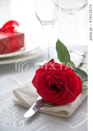 Festive or romantic dinner with red rose and gift. Festive or romantic dinner with red rose and gift. 47622674