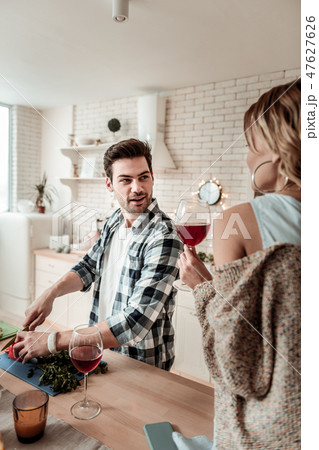 Dark-haired handsome man in a checkered shirt having fun with vegetables 47627626
