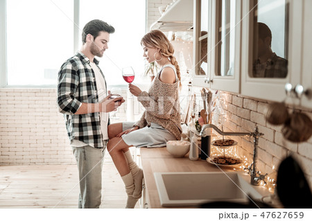 Sweet young long-haired woman in white socks sitting on the table 47627659