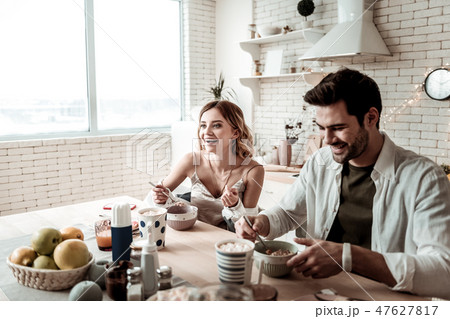 Young long-haired pretty woman in a white shirt and her husband feeling amazing Young long-haired pretty woman in a white shirt and her husband feeling amazing 47627817
