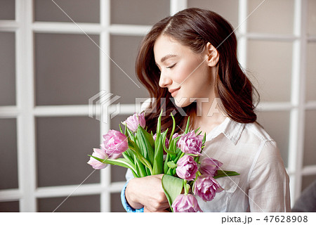 People, business, sale and floristry concept - close-up of florist woman holding bunch at flower People, business, sale and floristry concept - close-up of florist woman holding bunch at flower 47628908