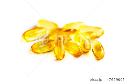 heap of fish oil supplement capsules 47629005