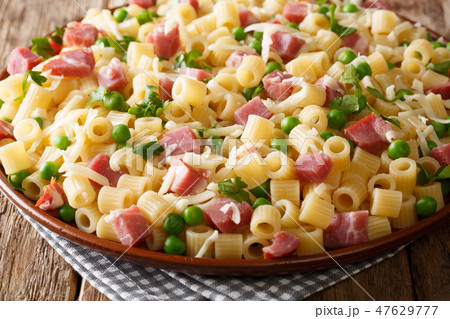 Ditalini pasta served with green peas, ham 47629777