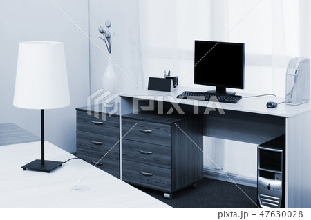 computer on a desk in a office computer on a desk in a office 47630028