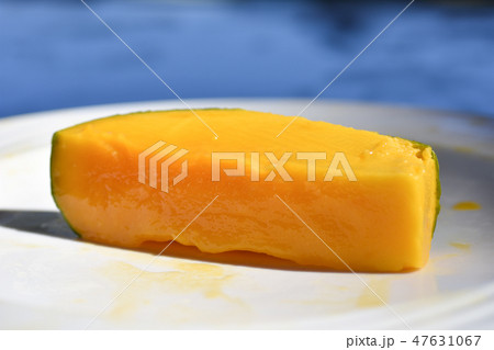 Cut juicy mango fruit in a plate on the beach 47631067