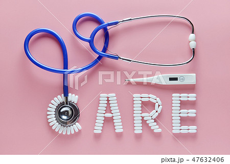 CARE word made by medicine pills, pink background. 47632406