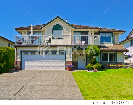Average residential house with concrete driveway on blue sky background Average residential house with concrete driveway on blue sky background 47633375