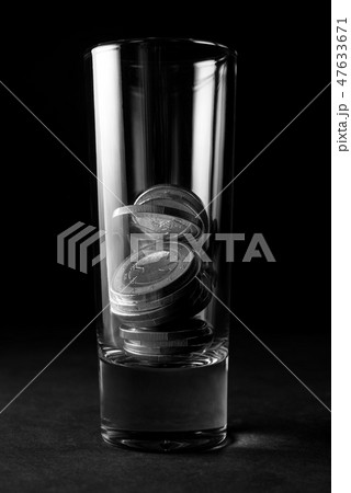 Glass for alcohol with Euro coins.  47633671