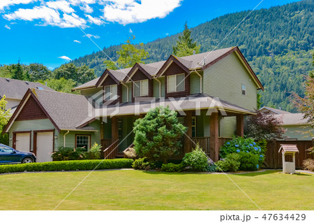 Big family house with draw-well decorating the yard on blue sky background 47634429