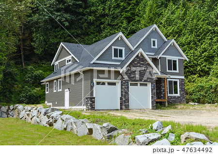 Brand new luxury residential house on green trees background 47634492
