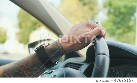 A brutal bearded man drives a car. A brutal bearded man drives a car. 47635157