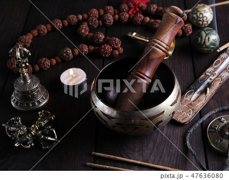 copper singing bowl and a wooden stick copper singing bowl and a wooden stick 47636080