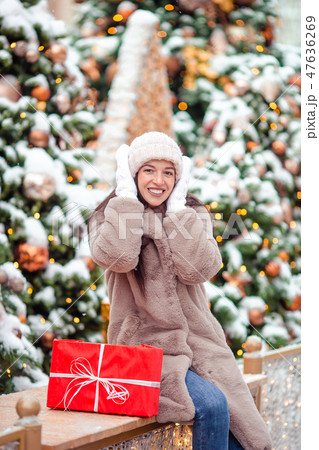 Happy girl near fir-tree branch in snow for new year. Happy girl near fir-tree branch in snow for new year. 47636269