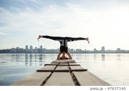 Young woman practicing yoga exercise at quiet wood Young woman practicing yoga exercise at quiet wood 47637140
