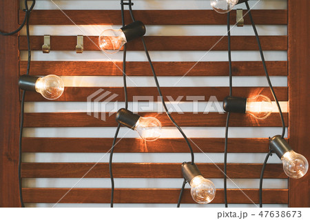 Light bulbs on Wooden Background. 47638673