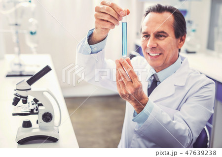 Experienced mature bioengineer testing new medicine Experienced mature bioengineer testing new medicine 47639238