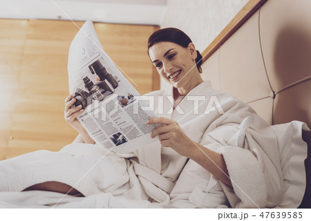 Beautiful housewife reading fresh press 47639585