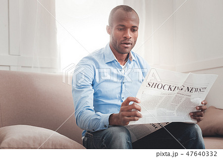 Nice serious man sitting on the sofa Nice serious man sitting on the sofa 47640332