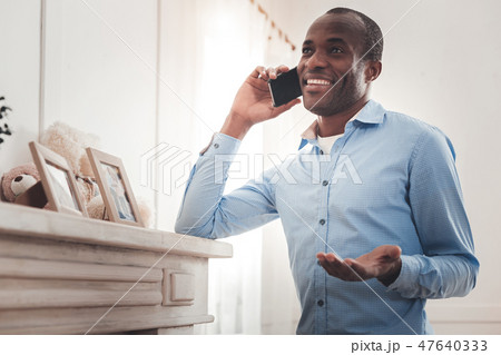 Joyful afro American man talking to his friend Joyful afro American man talking to his friend 47640333