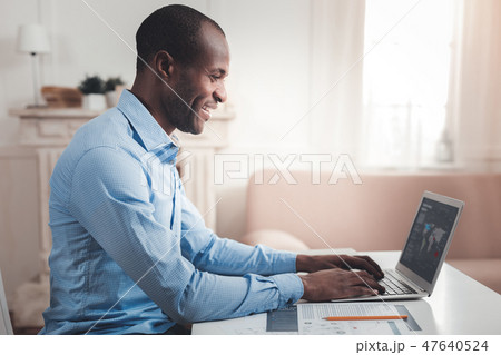 Smart cheerful man working Smart cheerful man working 47640524