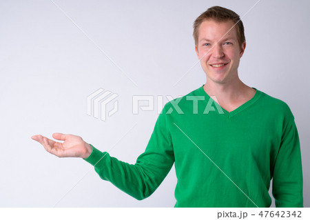 Portrait of happy young handsome man showing something Portrait of happy young handsome man showing something 47642342