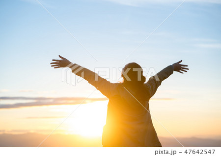 Happy woman standing alone with arms raised up. Happy woman standing alone with arms raised up. 47642547