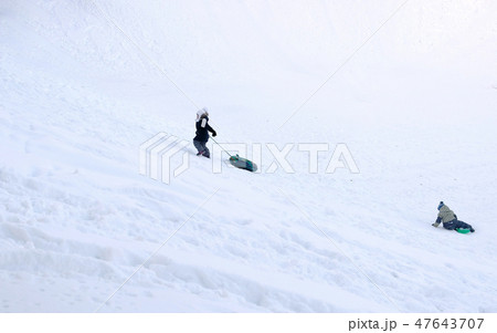 Children ride from the snowy mountains in the tubing in the winter Park. Children ride from the snowy mountains in the tubing in the winter Park. 47643707