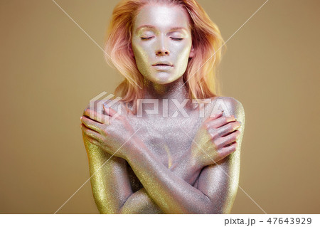 Golden Girl. Beautiful Young Woman with Sparkles 47643929