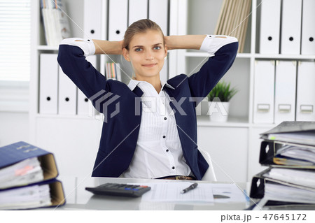 Happy business woman or female accountant having some minutes for time off and pleasure at working Happy business woman or female accountant having some minutes for time off and pleasure at working 47645172