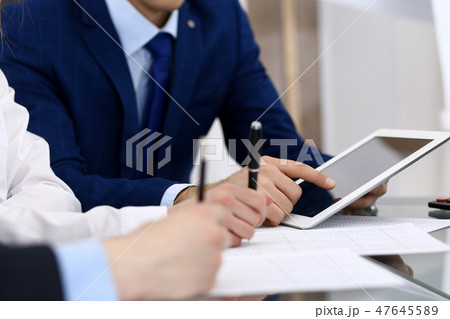 Businessman using laptop at meeting, closeup of hands. Business operations concept Businessman using laptop at meeting, closeup of hands. Business operations concept 47645589