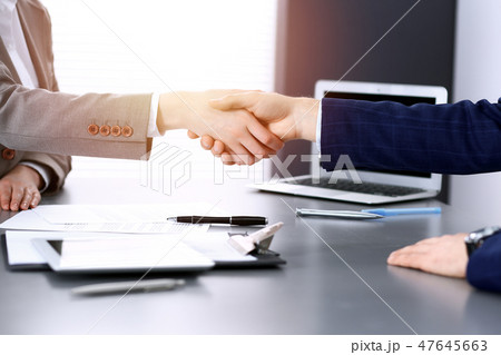 Business people shaking hands, finishing up a meeting. Papers signing, agreement and lawyer 47645663
