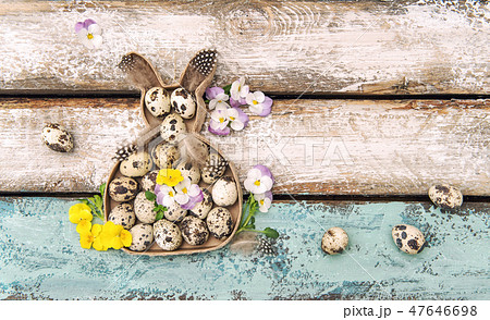 Easter decoration rabbit eggs pansy flowers 47646698