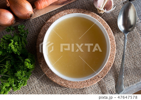 Chicken bone broth with vegetables, top view 47647578