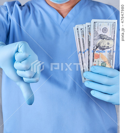 doctor in blue uniform and latex gloves  47647980