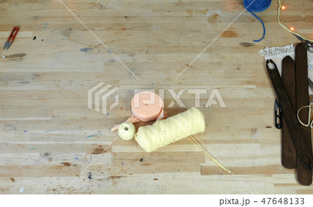 Workplace in sewing and weaving workshop with scissors, yarn, wooden table and shuttle. Workplace in sewing and weaving workshop with scissors, yarn, wooden table and shuttle. 47648133