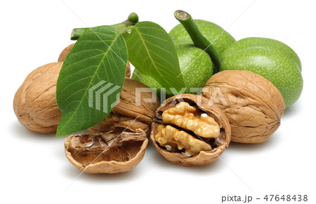Walnuts and cracked walnut with leaves Walnuts and cracked walnut with leaves 47648438