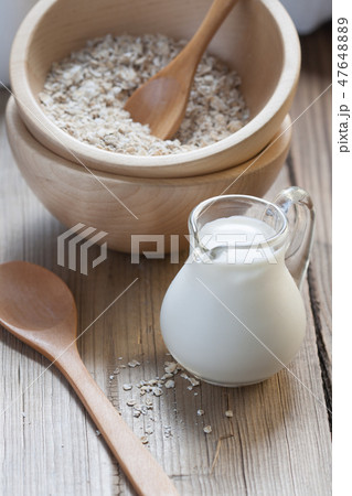 Wooden bowls and a small jug on the wooden table Wooden bowls and a small jug on the wooden table 47648889