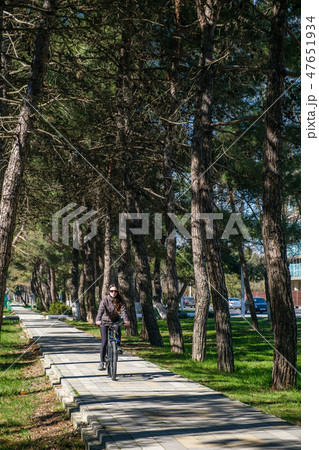 Beautiful smiling girl is riding the bicycle in the park 47651934