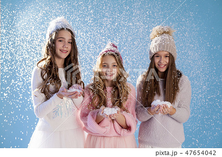 three fashionable girls in winter knitted hats snow winter three fashionable girls in winter knitted hats snow winter 47654042