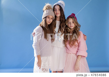 three fashionable girls girlfriend in winter knitted hats 47654086