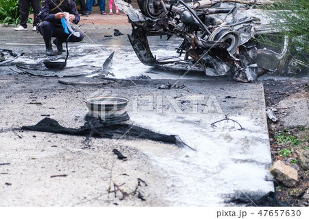 Burned car after an accident on the road. Police at the scene of the accident. Burned car after an accident on the road. Police at the scene of the accident. 47657630