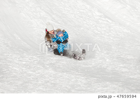 Mother and son fun slide down a snow hill on a Sunny winter's day 47659594
