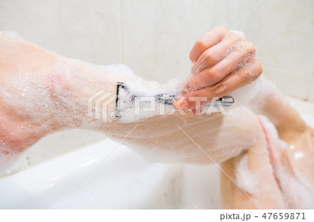 Beautiful young woman enjoying pleasant bath with foam 47659871
