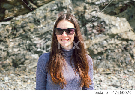 woman Enjoying Beautiful Sunset at the Beach 47660020
