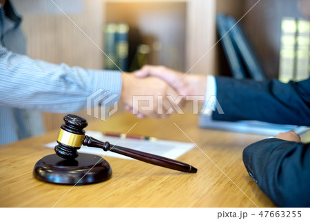 Justice lawyers Handshake to businessman or client Justice lawyers Handshake to businessman or client 47663255
