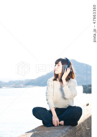 音楽を聴く若い女性 音楽を聴く若い女性 47663360