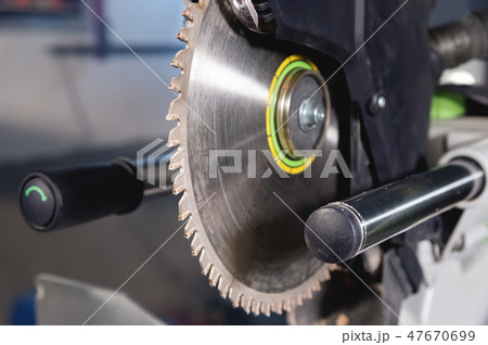 Close-up manual circular saw on slides for sawing wood in the home workshop 47670699
